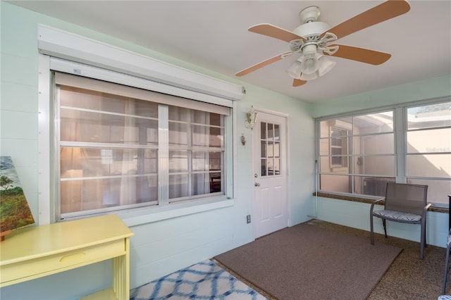 sunroom featuring a ceiling fan