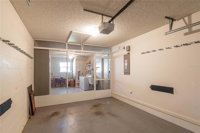 garage with a garage door opener, electric panel, and washing machine and clothes dryer