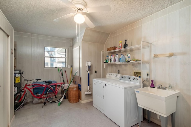 laundry room featuring washing machine and dryer, a sink, a textured ceiling, ceiling fan, and laundry area