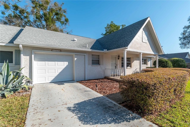 view of front of property with brick siding, a shingled roof, concrete driveway, covered porch, and an attached garage