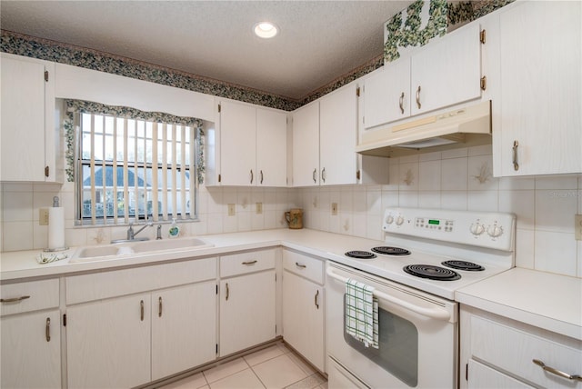 kitchen featuring a textured ceiling, under cabinet range hood, white electric range, a sink, and light countertops