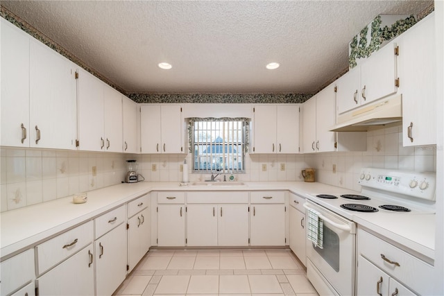 kitchen featuring white range with electric stovetop, light countertops, a sink, a textured ceiling, and under cabinet range hood