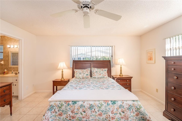 bedroom with light tile patterned floors, ceiling fan, connected bathroom, a textured ceiling, and baseboards