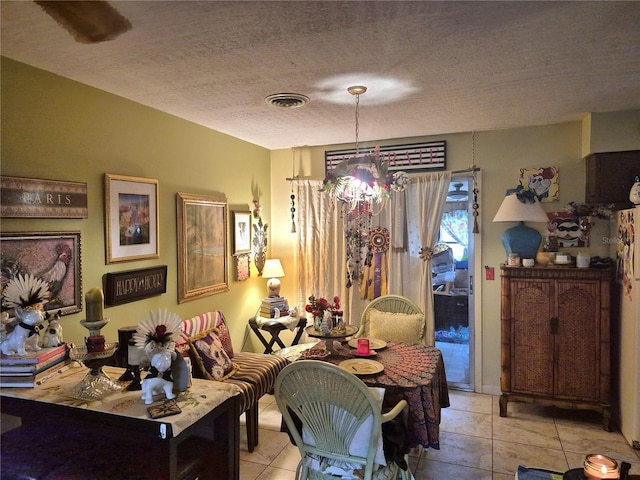 dining room featuring a textured ceiling, light tile patterned floors, and a chandelier