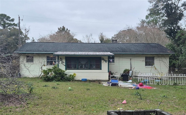 back of property featuring a lawn