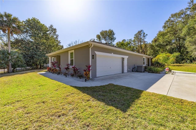 view of property exterior with central AC unit, a lawn, and a garage