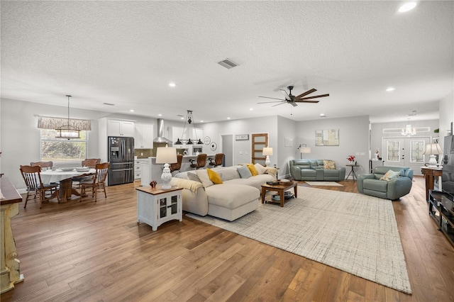 living room featuring a textured ceiling and light hardwood / wood-style flooring