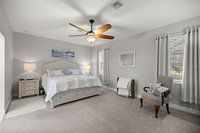 bedroom with ceiling fan and light carpet