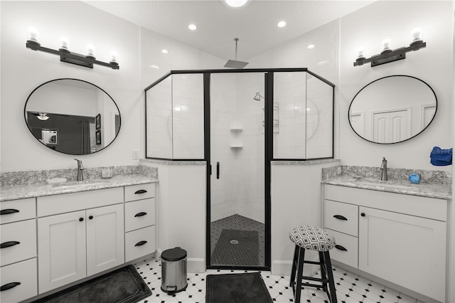 bathroom with walk in shower and vanity