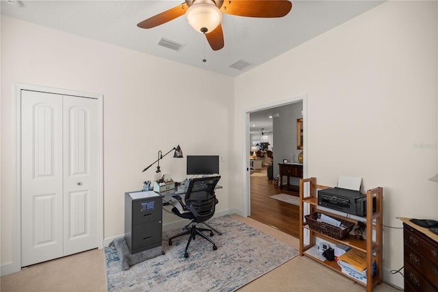 office area with light carpet and ceiling fan