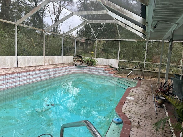 view of pool featuring a lanai and a patio