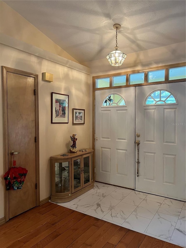 foyer featuring vaulted ceiling