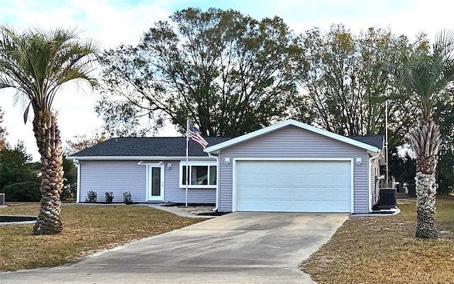 ranch-style home featuring central air condition unit, a garage, and a front lawn