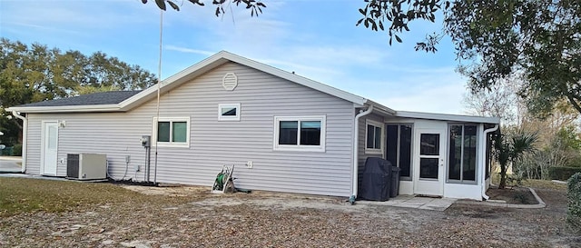 back of property featuring central AC and a sunroom