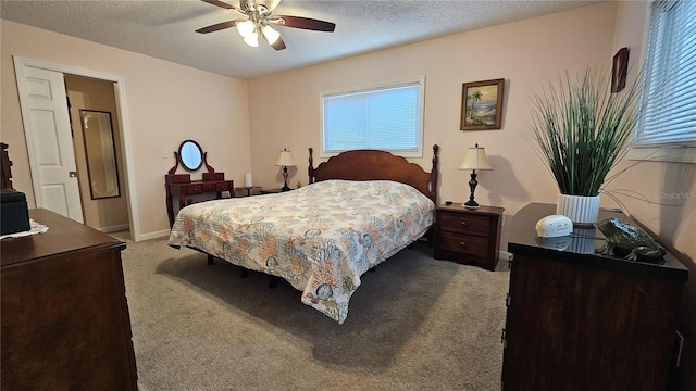 bedroom featuring a textured ceiling, ceiling fan, and carpet