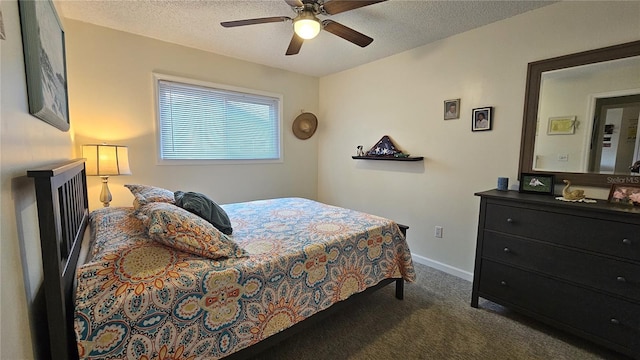 carpeted bedroom with a textured ceiling and ceiling fan