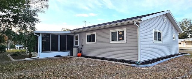 rear view of property with a sunroom