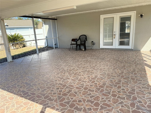 unfurnished sunroom featuring french doors