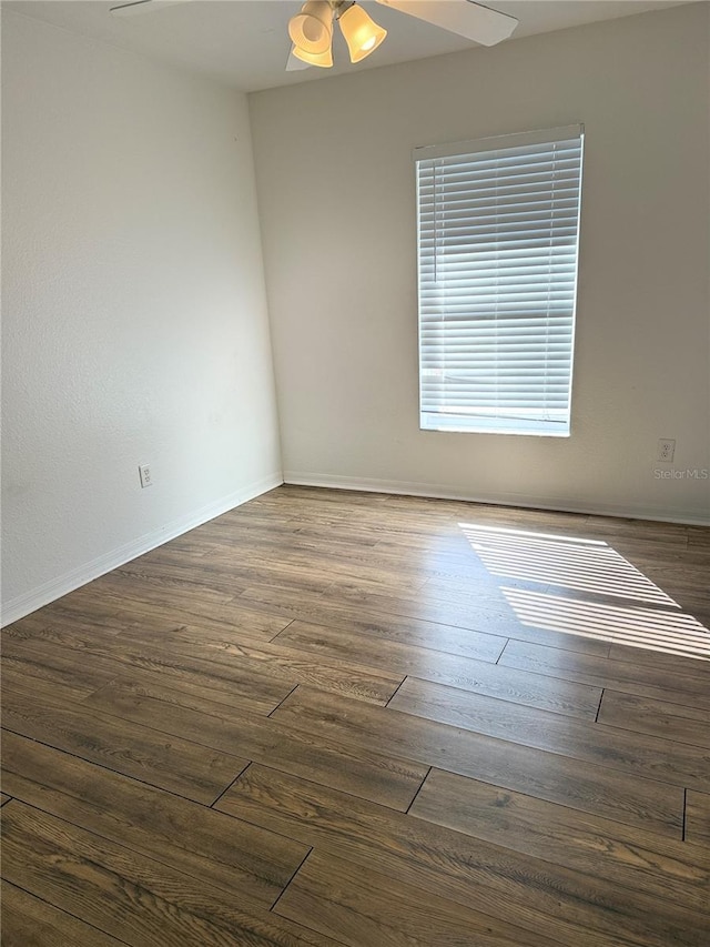 spare room featuring ceiling fan and dark hardwood / wood-style floors