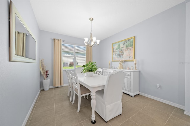 tiled dining room with a notable chandelier