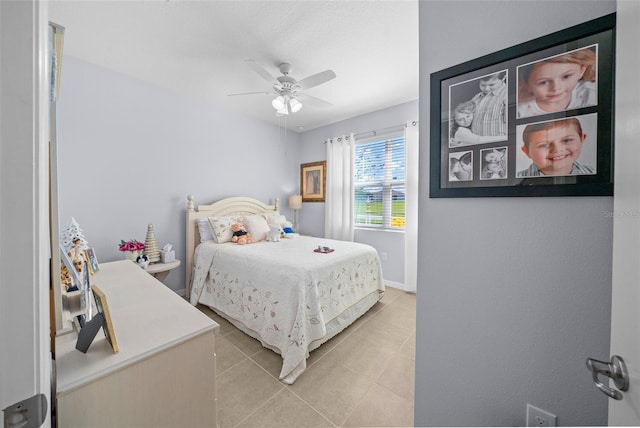 bedroom with ceiling fan and light tile patterned floors