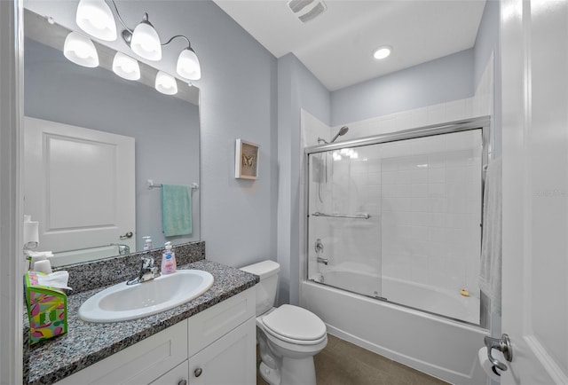 full bathroom with combined bath / shower with glass door, toilet, tile patterned floors, and vanity