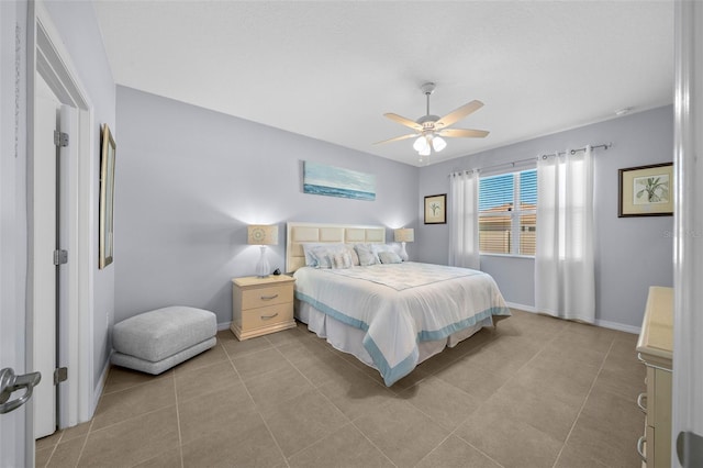 tiled bedroom featuring ceiling fan