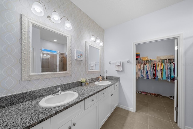 bathroom with tile patterned floors, vanity, and an enclosed shower