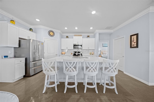 kitchen featuring sink, an island with sink, white cabinets, and appliances with stainless steel finishes