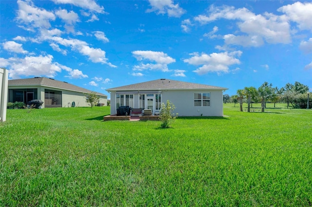 back of property with a lawn