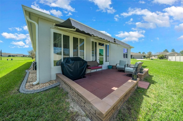 back of house with a patio area and a yard