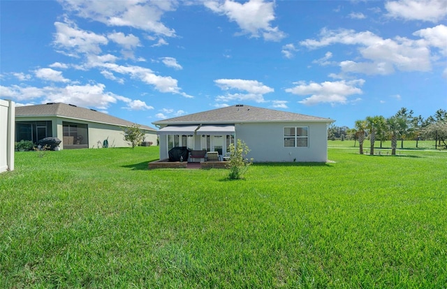 rear view of property featuring a patio, a gazebo, and a yard