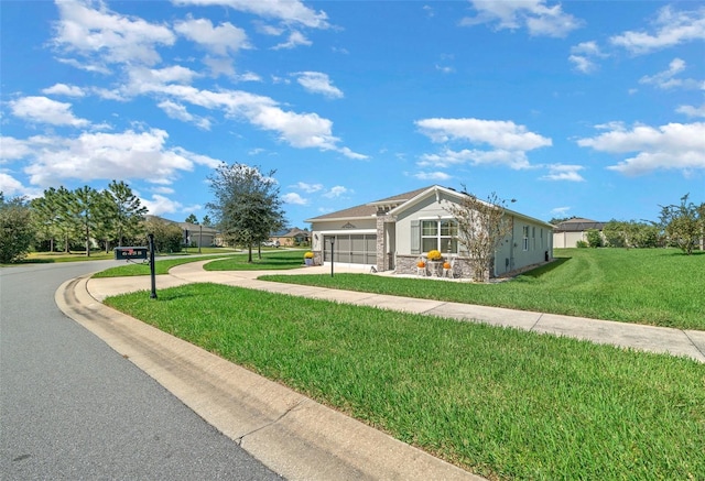 view of front of property with a garage and a front lawn