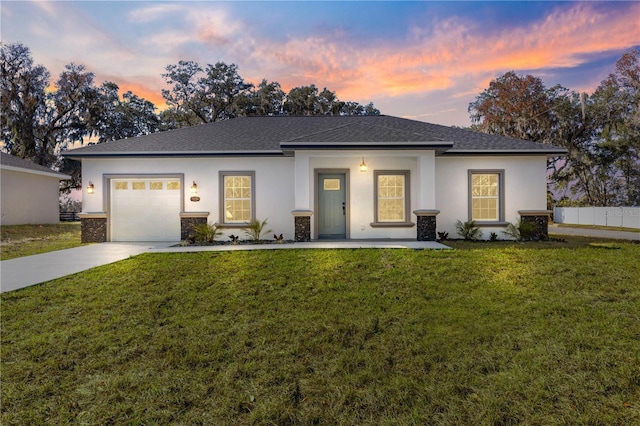 prairie-style home with a garage and a yard