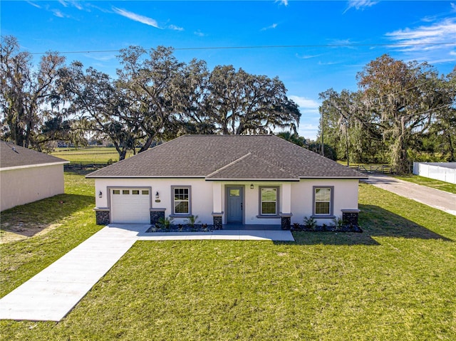 view of front of property with a garage and a front yard