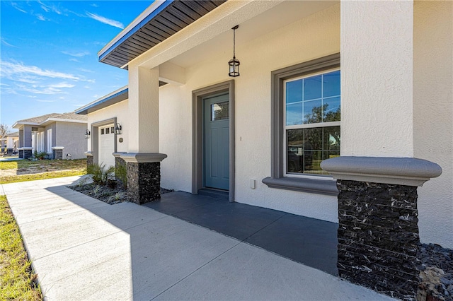 property entrance with a garage and central AC