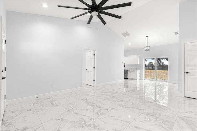 unfurnished living room with ceiling fan and high vaulted ceiling