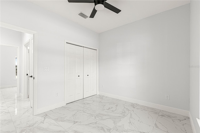 unfurnished bedroom featuring vaulted ceiling, ceiling fan, and a closet