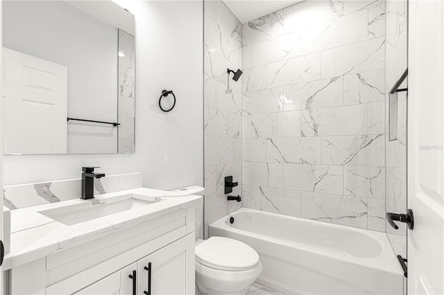 full bathroom featuring tiled shower / bath combo, vanity, and toilet