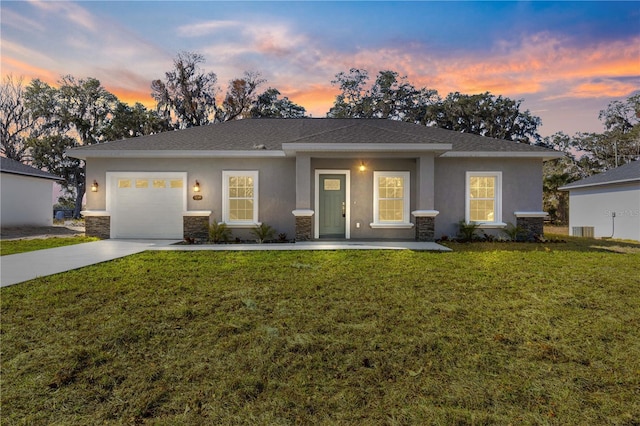 view of front facade featuring a garage and a lawn