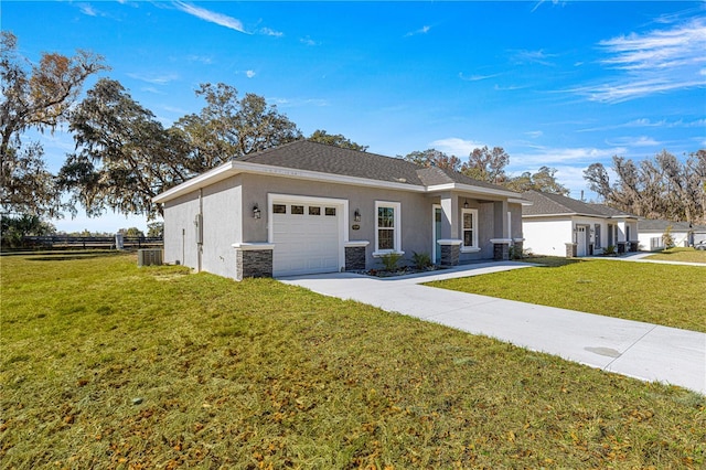 view of front facade featuring cooling unit, a garage, and a front lawn