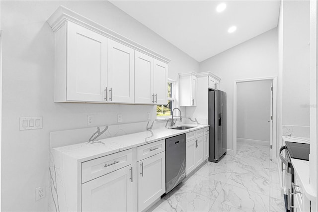 kitchen with vaulted ceiling, appliances with stainless steel finishes, sink, white cabinets, and light stone countertops