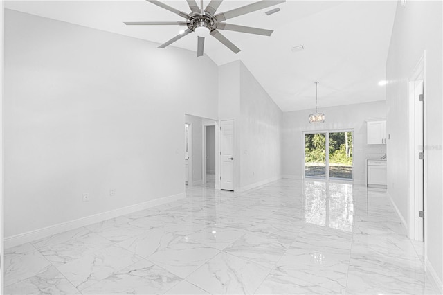 unfurnished room featuring ceiling fan with notable chandelier and high vaulted ceiling