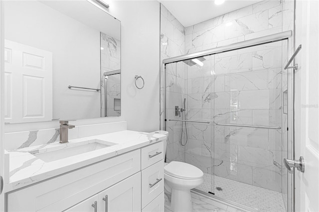 bathroom with vanity, an enclosed shower, and toilet