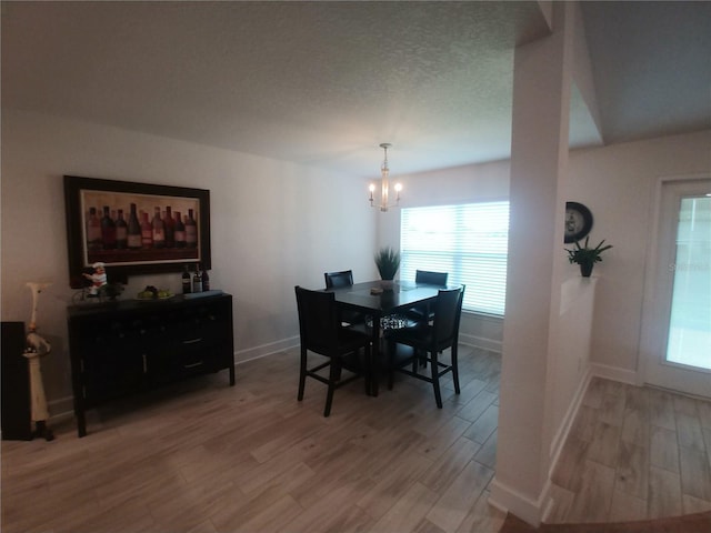 dining area featuring a notable chandelier and hardwood / wood-style flooring