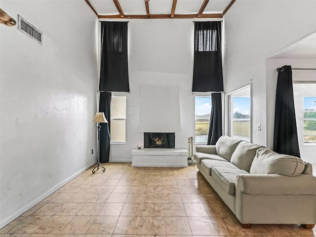 tiled living room with a towering ceiling