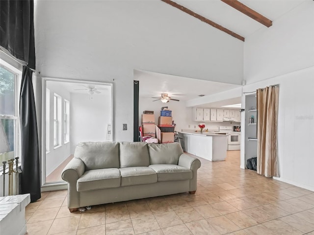 living room with ceiling fan, beamed ceiling, light tile patterned floors, and high vaulted ceiling