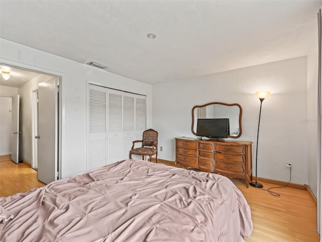 bedroom featuring light wood-type flooring and a closet