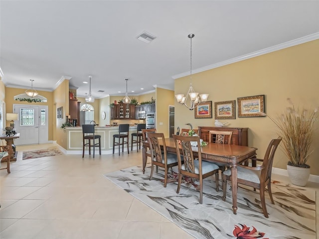 tiled dining space featuring crown molding and a notable chandelier