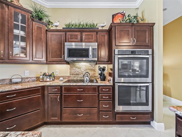 kitchen with appliances with stainless steel finishes, backsplash, light stone counters, ornamental molding, and light tile patterned flooring